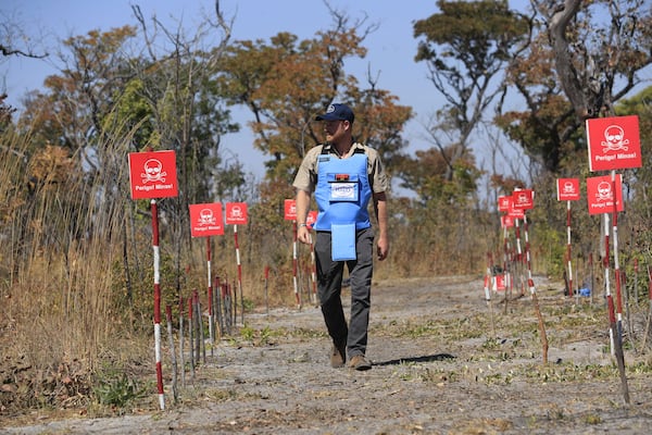 Britain's Prince Harry walks through a minefield during a visit to see the work of landmine clearance charity of the Halo Trust, in Cuito Cuanavale, Cuando province, southern Angola, Wednesday, July 16, 2025. (Ampe Pedro/The Halo Trust via AP)