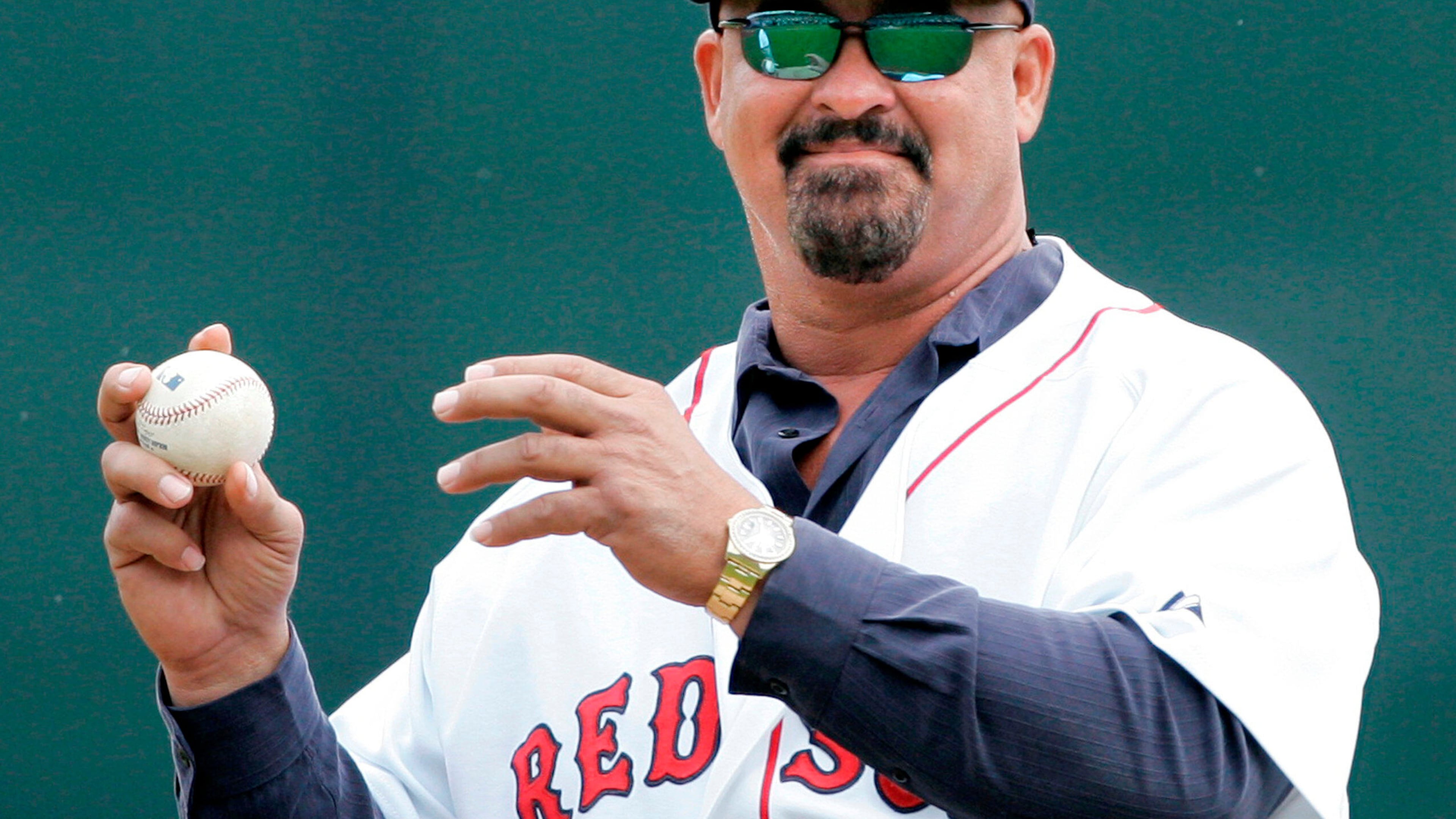 FILE - Former Boston Red Sox pluaer Mike Greenwell sets to throw out the ceremonial first pitch prior to the Red Sox-New York Mets spring training baseball game in Fort Myers, Fla., Tuesday March 11, 2008. (AP Photo/Charles Krupa, File)