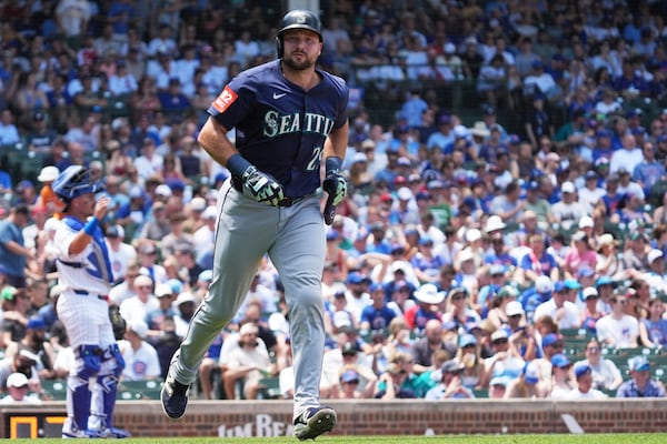 Seattle Mariners' Cal Raleigh walks to first base during the third inning of a baseball game against the Chicago Cubs in Chicago, Sunday, June 22, 2025. (AP Photo/Nam Y. Huh)