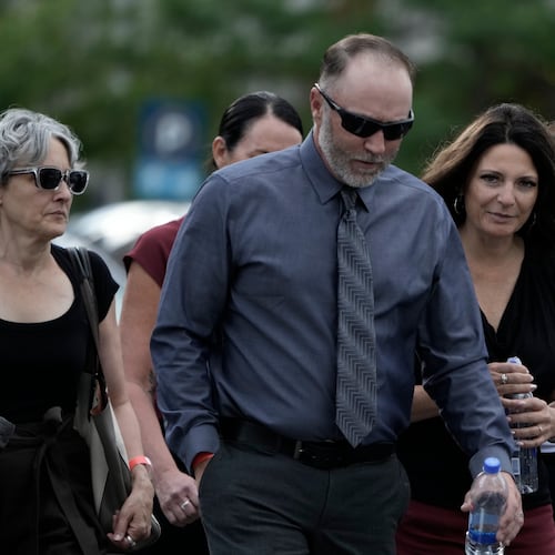 Matt Robinson, father, and Amber Robinson, mother, second right, of Tyler Robinson arrive at the Fourth District Courthouse, Tuesday, July 7, 2026, in Provo, Utah, ahead of a hearing for Tyler Robinson, accused in the fatal shooting of Charlie Kirk. (AP Photo/Spenser Heaps)