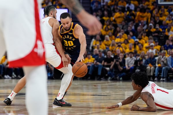 Houston Rockets forward Dillon Brooks, left, collide with Golden State Warriors guard Stephen Curry (30) during the first half of Game 4 of an NBA basketball first-round playoff series Monday, April 28, 2025, in San Francisco. (AP Photo/Godofredo A. Vásquez)