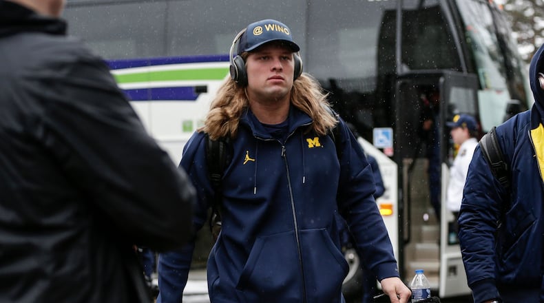 Michigan defensive line Chase Winovich walks off the bus as the team arrive at Ohio Stadium in Columbus, Ohio before the OSU game, Saturday, Nov. 24, 2018.