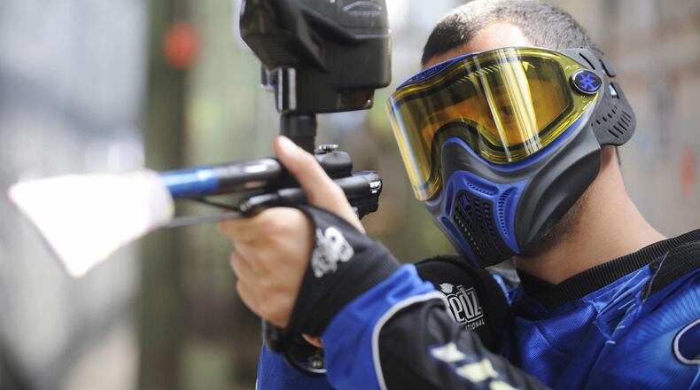 A German paintball enthusiast poses with his weapon in a paintball hall in Berlin in May 2009.