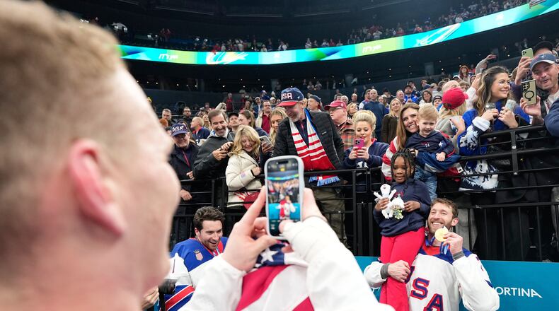 FILE - United States' Jaccob Slavin (74) poses with his gold medal after the men's ice hockey gold medal game between Canada and the United States at the 2026 Winter Olympics, in Milan, Italy, Feb. 22, 2026. (AP Photo/Hassan Ammar, File)