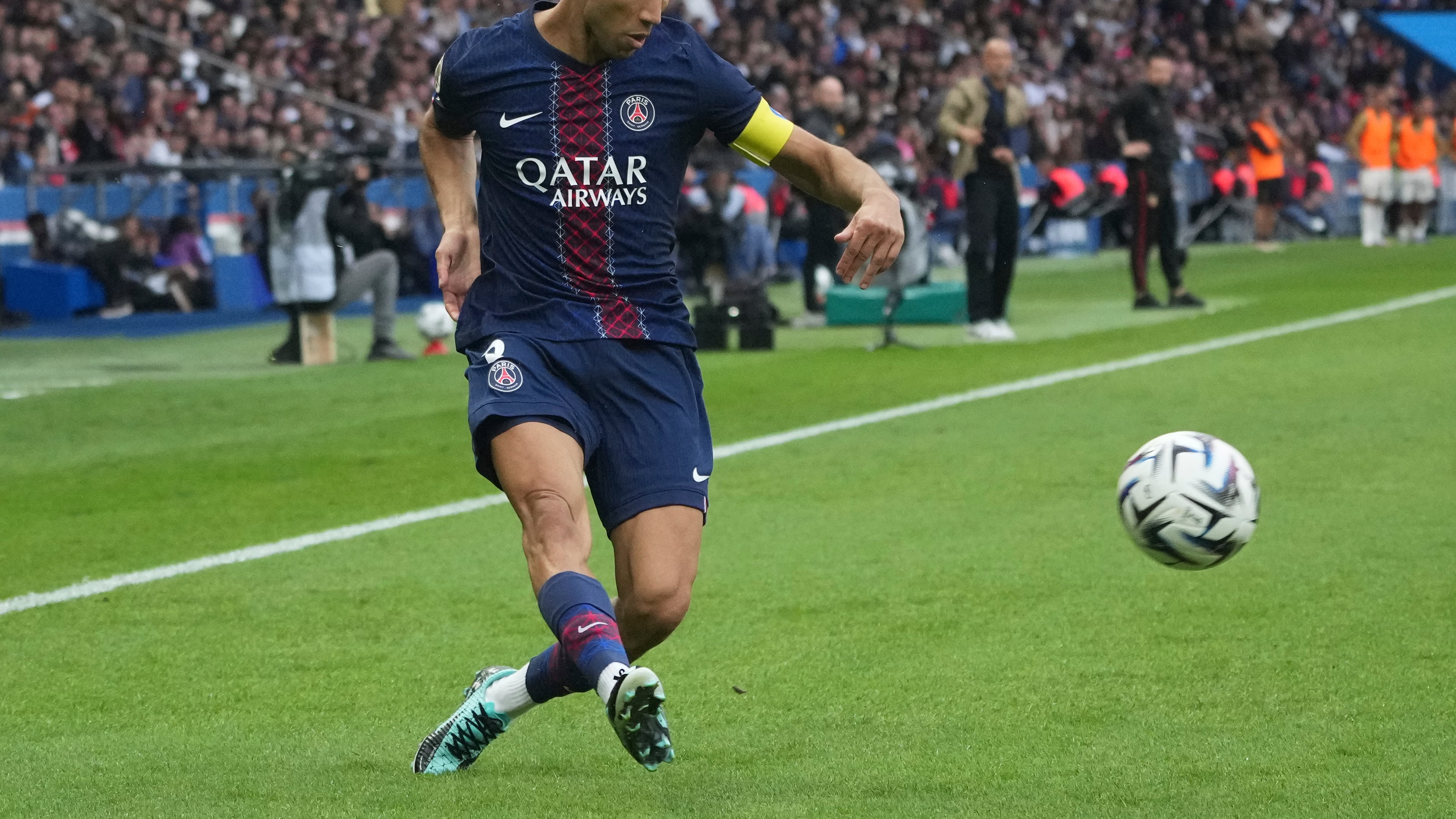 PSG's Achraf Hakimi plays the ball during the French League One soccer match between Paris Saint-Germain and Lens at the Parc des Princes stadium in Paris, Sunday, Sept. 14, 2025. (AP Photo/Michel Euler)