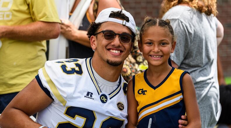 Georgia Tech safety Jalen Johnson (23) poses for a photo with his little sister during Fan Day at Bobby Dodd Stadium on Aug. 12, 2017. -- Danny Karnik/GT Athletics