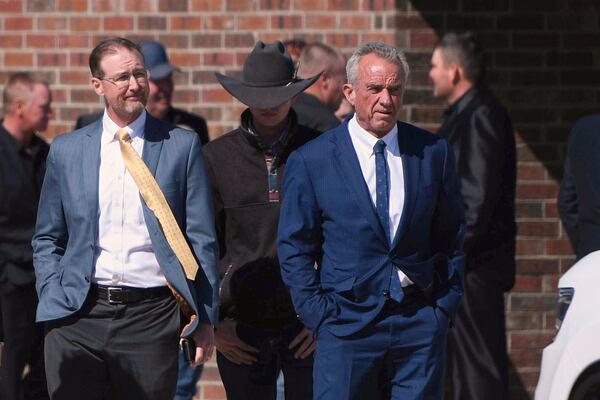 FILE - Health and Human Services Secretary Robert F. Kennedy Jr., right, arrives at Reinlander Mennonite Church in Seminole, Texas, on Sunday, April 6, 2025, after a second measles-related death in the state. (AP Photo/Annie Rice, File)
