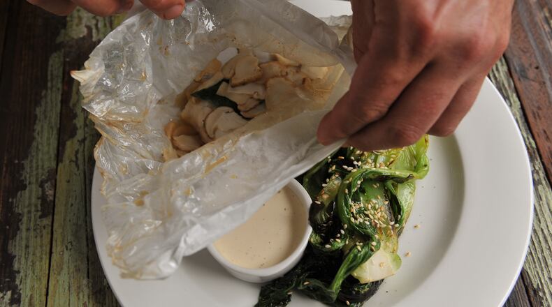 Hog snapper baked in parchment with matsutake mushrooms, bok choi and "umami" mayo at Cakes & Ale. (Beckysteinphotography.com)