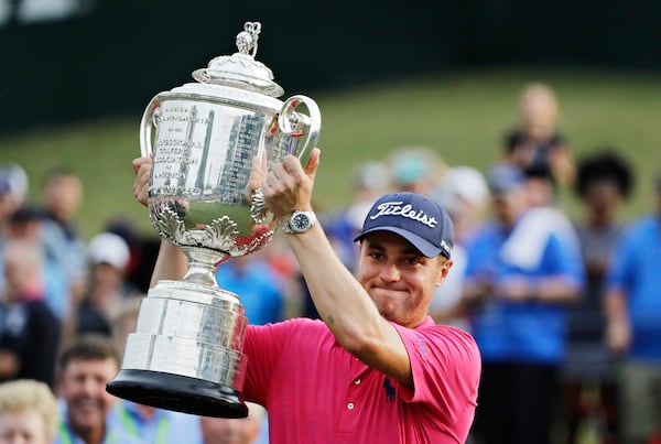 FILE - Justin Thomas poses with the Wanamaker Trophy after winning the PGA Championship golf tournament at the Quail Hollow Club Sunday, Aug. 13, 2017, in Charlotte, N.C. (AP Photo/Chris O'Meara, File)