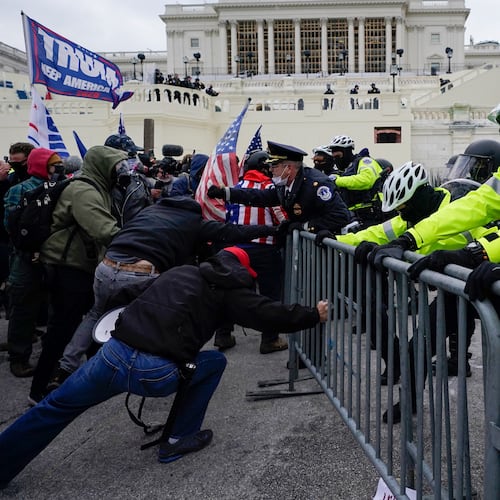 FILE - Metropolitan Police Department officers try to hold back rioters on the West Front at the U.S. Capitol on Jan. 6, 2021, in Washington. (AP Photo/Julio Cortez, File)