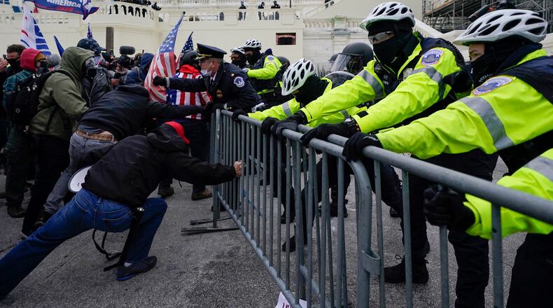 FILE - Metropolitan Police Department officers try to hold back rioters on the West Front at the U.S. Capitol on Jan. 6, 2021, in Washington. (AP Photo/Julio Cortez, File)