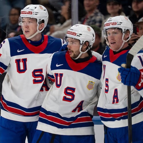 From left, USA's Mason Lohrei, Isaac Howard and Oliver Moore celebrate after their team's second goal, during the 2026 IIHF Men's Ice Hockey World Championship preliminary round group A game between Britain and the United States, in Zurich, Switzerland, Sunday, May 17, 2026. (Claudio Thoma/Keystone via AP)