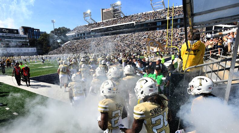 Georgia Tech's Ramblin' Wreck leads the band, cheerleaders, Buzz, players, and coaches before an NCAA college football game against Syracuse at Bobby Dodd Stadium, Saturday, Oct. 25, 2025, in Atlanta. (Hyosub Shin/AJC)