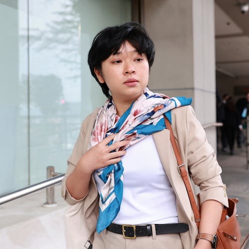 Selina Cheng, chair of the Hong Kong Journalists Association (HKJA) and a former reporter for The Wall Street Journal (WSJ), center, leaves Eastern Magistrates' Court during a session break during her case against the paper's parent company, Dow Jones Publishing Co (Asia) Inc., in Hong Kong on Thursday, Dec 18, 2025. (AP Photo/May James)