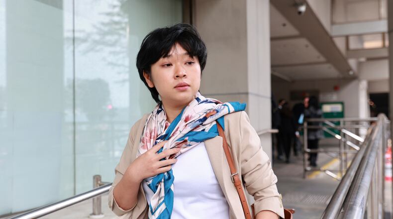 Selina Cheng, chair of the Hong Kong Journalists Association (HKJA) and a former reporter for The Wall Street Journal (WSJ), center, leaves Eastern Magistrates' Court during a session break during her case against the paper's parent company, Dow Jones Publishing Co (Asia) Inc., in Hong Kong on Thursday, Dec 18, 2025. (AP Photo/May James)