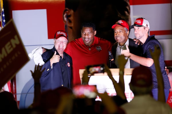 South Carolina U.S. Sen. Lindsay Graham (from left), Herschel Walker, former U.S. Secretary of Housing and Urban Development Ben Carson and radio host Clay Travis rally for Walker in in Kennesaw. (Miguel Martinez/AJC 2022)