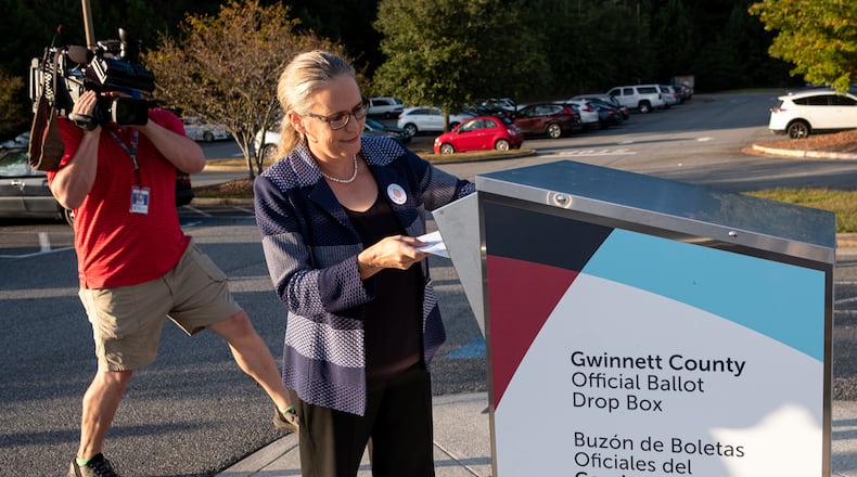 201020-Suwanee-Carolyn Bourdeaux, who is running for Georgia’s 7th congressional district, drops her ballot in a drop box at Georgia Pierce Park in Suwanee on Tuesday evening, October 20, 2020. Ben Gray for the Atlanta Journal-Constitution