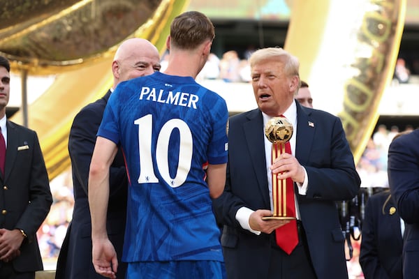 President Donald Trump presents Chelsea's Cole Palmer with the golden ball trophy after Chelsea won against Paris St Germain in the Club World Cup final at MetLife Stadium in East Rutherford, N.J., Sunday, July 13, 2025. (Kevin Lamarque/Pool Photo via AP)
