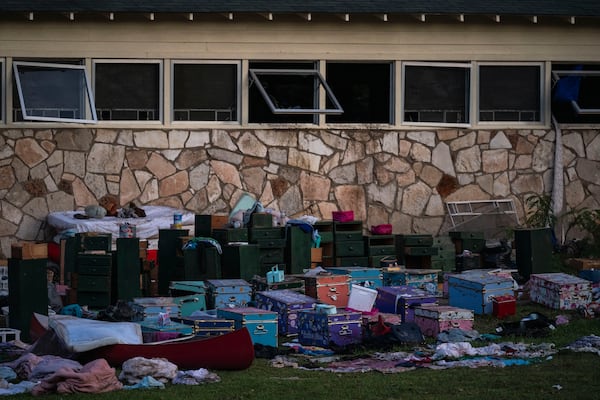 Camper's belongings sit outside one of Camp Mystic's cabins near the Guadalupe River after a flash flood swept through the area Monday, July 7, 2025, in Hunt, Texas. (AP Photo/Eli Hartman)