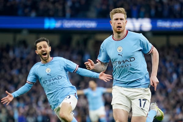 FILE - Manchester City's Kevin De Bruyne celebrates with Manchester City's Bernardo Silva, left, after scoring the opening goal during the English Premier League soccer match between Manchester City and Arsenal at Etihad stadium in Manchester, England, Wednesday, April 26, 2023. (AP Photo/Dave Thompson, file)