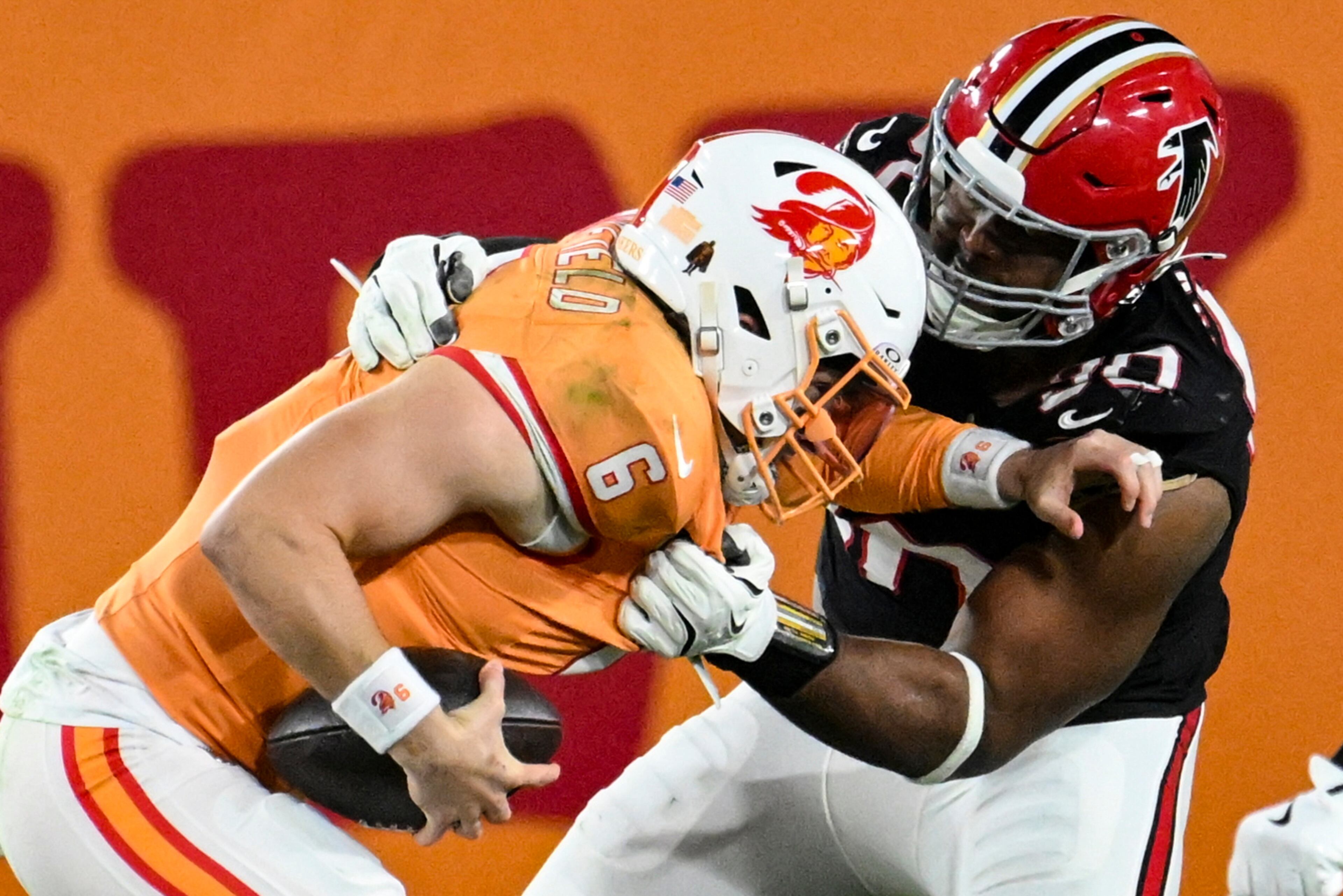 Atlanta Falcons defensive tackle David Onyemata (90) sacks Tampa Bay Buccaneers quarterback Baker Mayfield (6) during the first half of an NFL football game, Thursday, Dec. 11, 2025, in Tampa, Fla. (AP Photo/Jason Behnken)