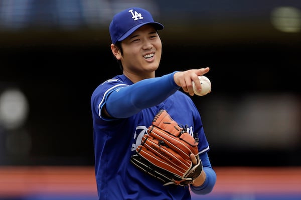 Los Angeles Dodgers' Shohei Ohtani (17), of Japan, reacts while throwing live batting practice before a baseball game against the New York Mets on Sunday, May 25, 2025, in New York. (AP Photo/Adam Hunger)