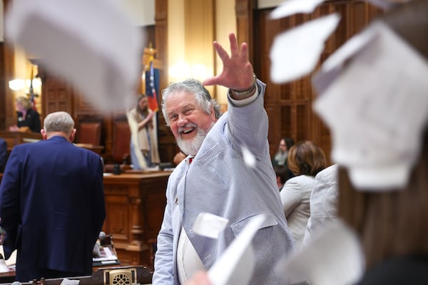 State Rep. Emory Dunahoo, R-Gillsville, tosses papers in the House of Representatives on the final day of the legislative session in April. (Arvin Temkar/AJC)