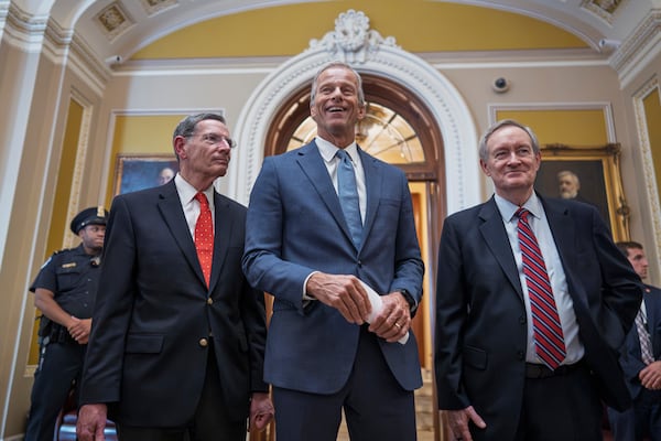 Senate Majority Leader John Thune, R-S.D., is flanked by Sen. John Barrasso, R-Wyo., the GOP whip, left, and Finance Committee Chairman Mike Crapo, R-Idaho, as he speaks to reporters just after passage of the budget reconciliation package of President Donald Trump's signature bill of big tax breaks and spending cuts, at the Capitol in Washington, Tuesday, July 1, 2025. The bill now moves back to the House for final consideration. (AP Photo/J. Scott Applewhite)