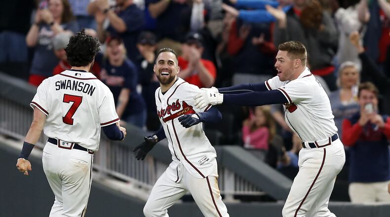 Ender Inciarte is congratulated by Freddie Freeman and Dansby Swanson after his successful walk-off bunt in the ninth inning of Saturday's 4-3 win over the Mets. (Photo by Mike Zarrilli/Getty Images)