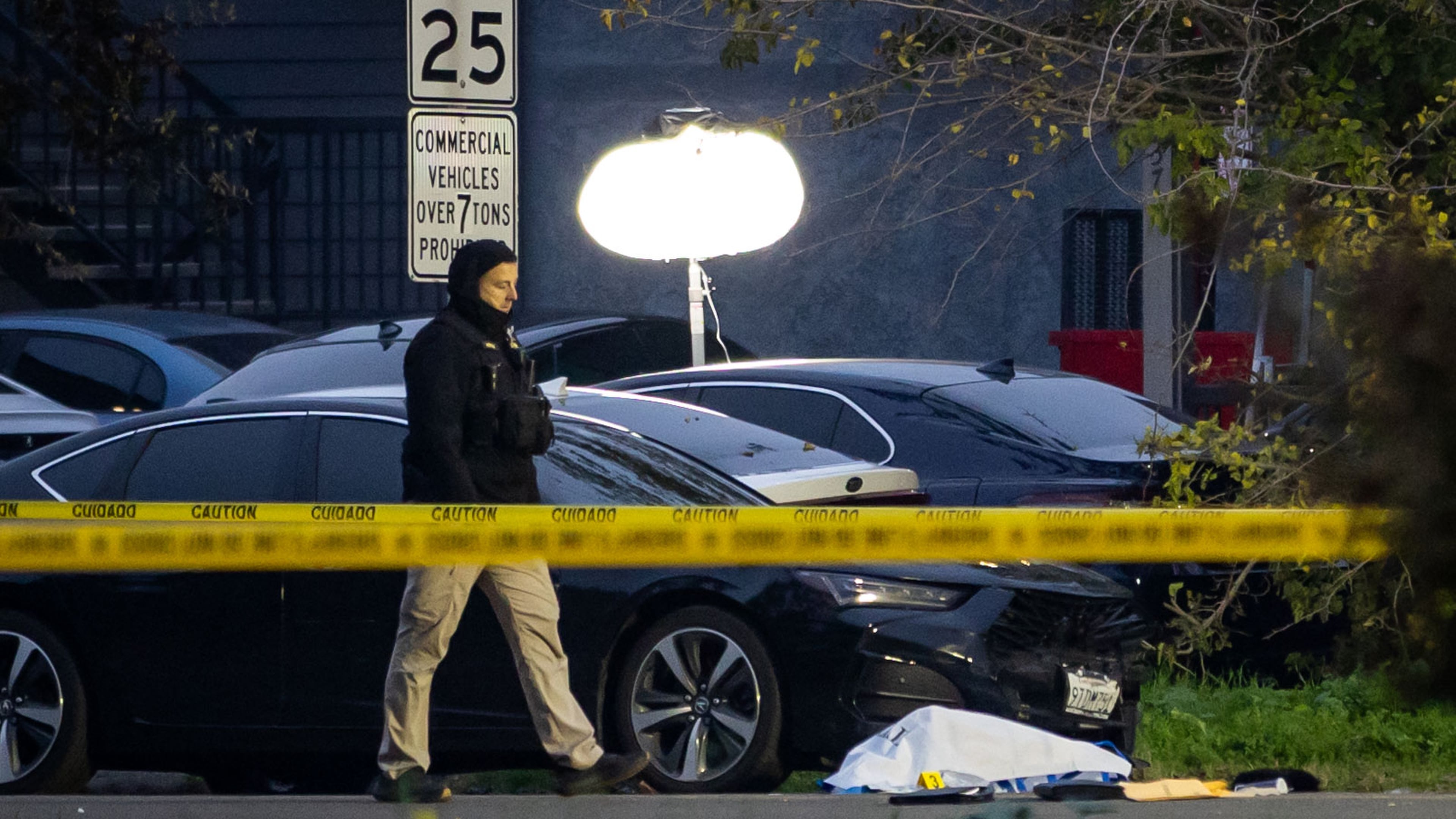 Investigators examine the scene of a mass shooting Sunday, Nov. 30, 2025, in Stockton, Calif. (AP Photo/Ethan Swope)