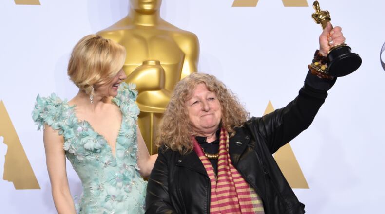 Actress Cate Blanchett (L) watches as Jenny Beavan celebrates with her Oscar for Best Costume Design, "Mad Max: Fury Road," in the press room during the 88th Oscars in Hollywood on February 28, 2016. AFP PHOTO/FREDERIC J. BROWN / AFP / FREDERIC J. BROWN