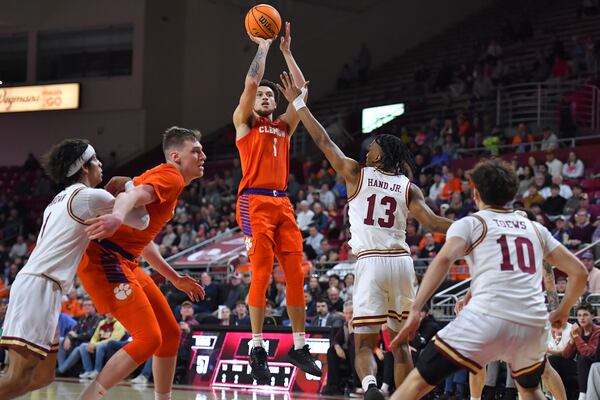 Clemson guard Chase Hunter (1) takes a shot at the basket as Boston College guard Donald Hand Jr. (13) defends in the second half of an NCAA college basketball game, Wednesday, March 5, 2025, in Boston. (AP Photo/Steven Senne)