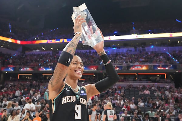 New York Liberty's Natasha Cloud holds the trophy after winning the skills challenge at the WNBA All-Star basketball weekend, Friday, July 18, 2025, in Indianapolis. (AP Photo/Michael Conroy)