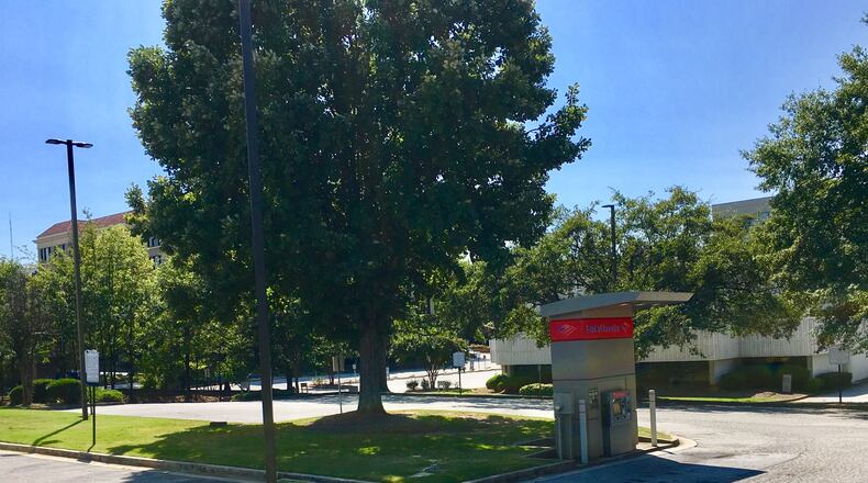 The Bank of America property in downtown Decatur, slated for re-development into mixed use including 232 apartments. A new bank will get built on the corner of Church Street and Commerce Drive, or roughly where this photo was taken. The current bank (background) gets replaced with an 80,000 square-foot office building. Bill Banks for the AJC.