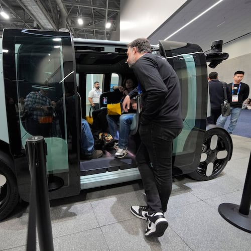 FILE - People view a Zoox self-driving vehicle at the Zoox booth during the CES tech show, Jan. 7, 2025, in Las Vegas. (AP Photo/John Locher, file)