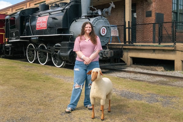 Kayla stands with her sheep statue at the "Antiques Roadshow" in Savannah, GA, on April 29, 2025. The sheep, made by a German designer, was purchased for $5 and appraised at $4,000. (Justin Taylor for The Atlanta Journal-Constitution)