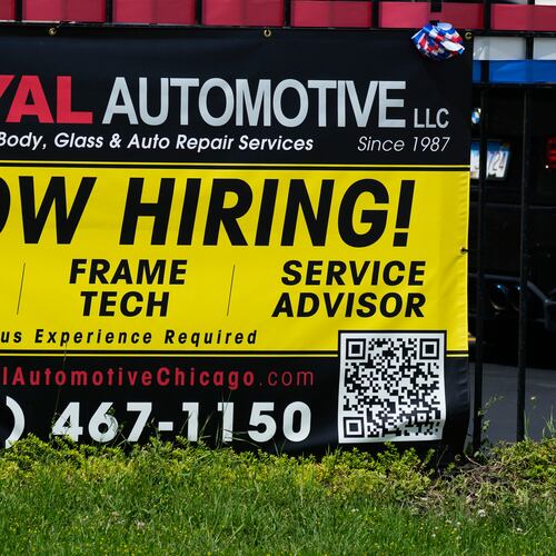 Now hiring sign is seen in front of an auto body shop in Chicago, Thursday, June 25, 2026. (AP Photo/Nam Y. Huh)