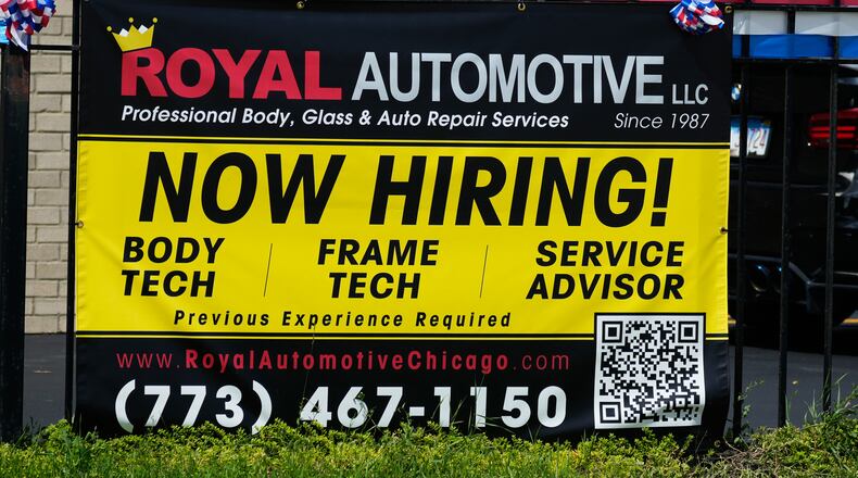 Now hiring sign is seen in front of an auto body shop in Chicago, Thursday, June 25, 2026. (AP Photo/Nam Y. Huh)