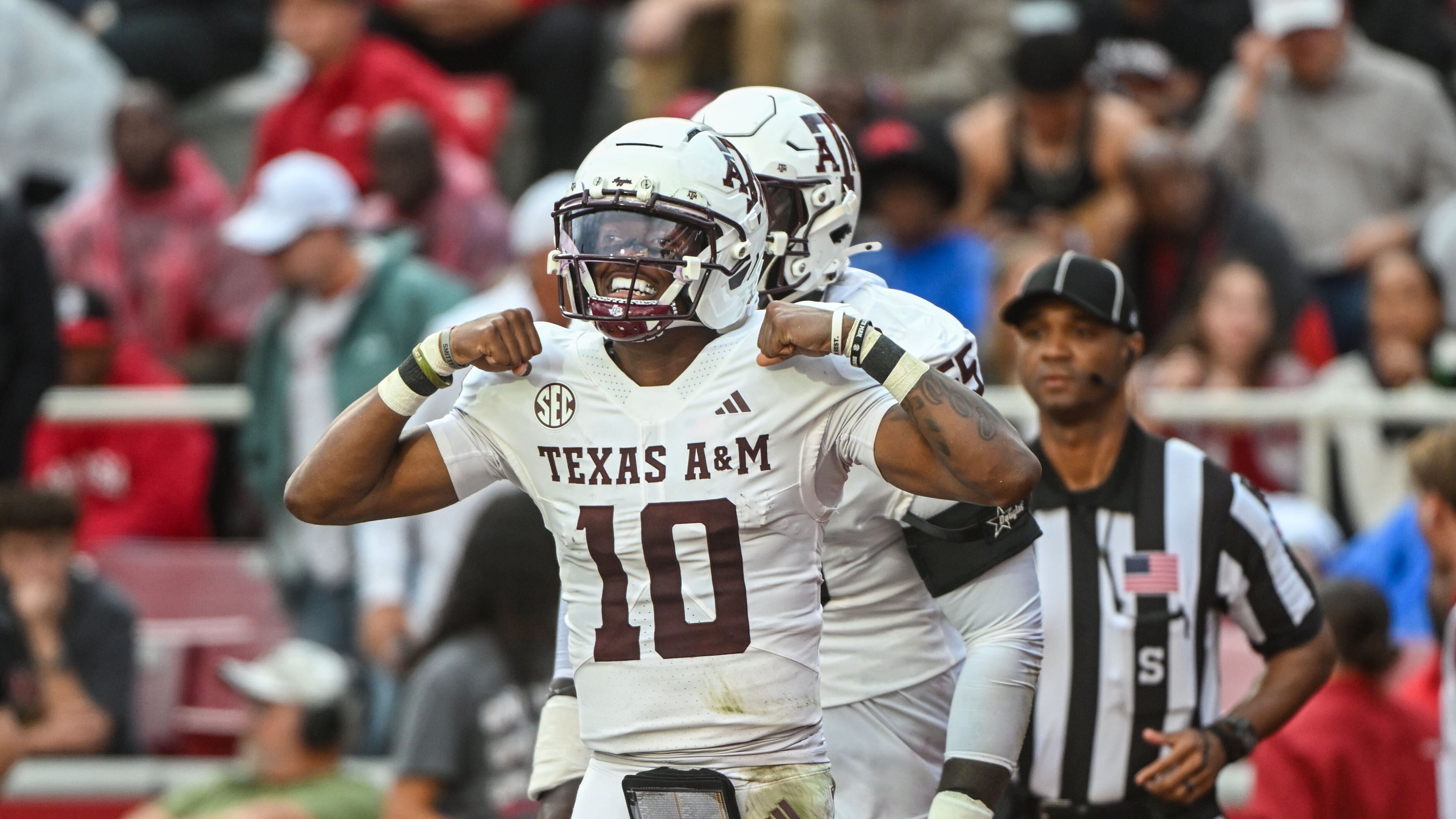 Texas A&M quarterback Marcel Reed (10) celebrates after running for a touchdown against Arkansas during the first half of an NCAA college football game Saturday, Oct. 18, 2025, in Fayetteville, Ark. (AP Photo/Michael Woods)