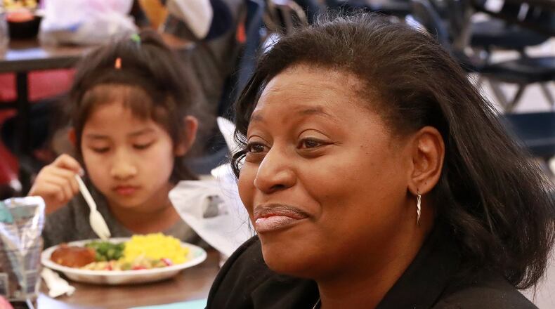 Principal Stephanie Brown-Bryant discusses the benefit of students having lunch served during spring break. Beauty Lay, 7, is one of hundreds enjoying their meal at Indian Creek Elementary School on Tuesday, April 2, 2019, in Clarkston. CURTIS COMPTON/CCOMPTON@AJC.COM
