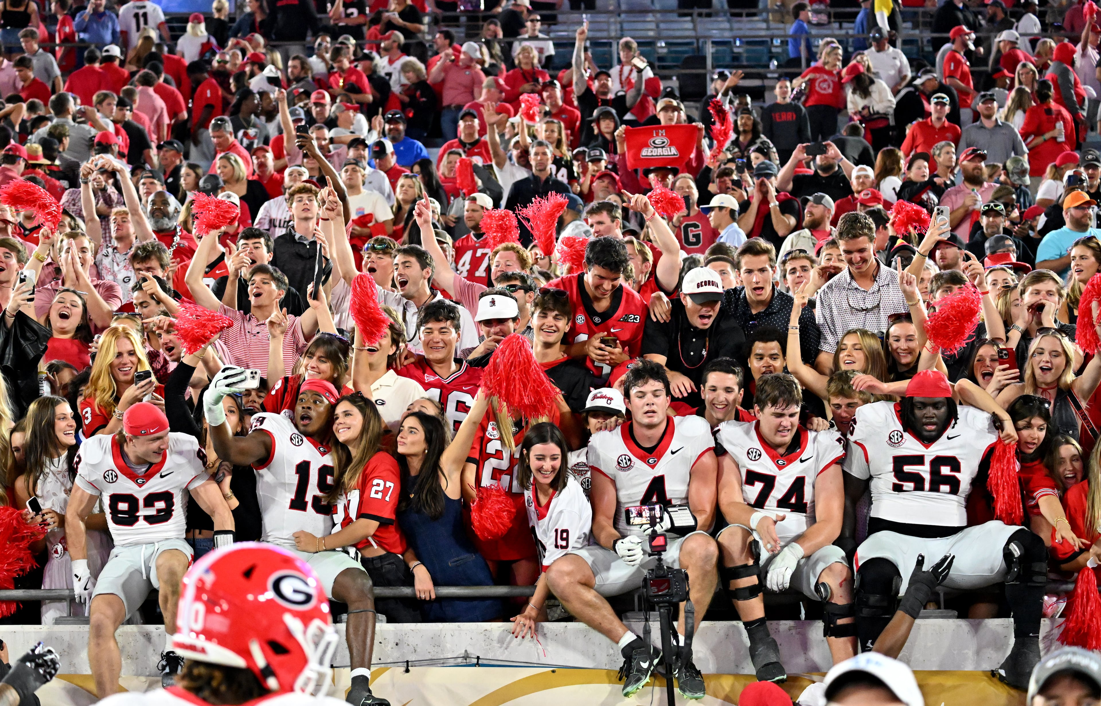 Georgia players celebrate with fans after Georgia beat Florida during an NCAA football game, Saturday, November 1, 2025, Jacksonville, Fla. Georgia won 24-20 over Florida. (Hyosub Shin / AJC)