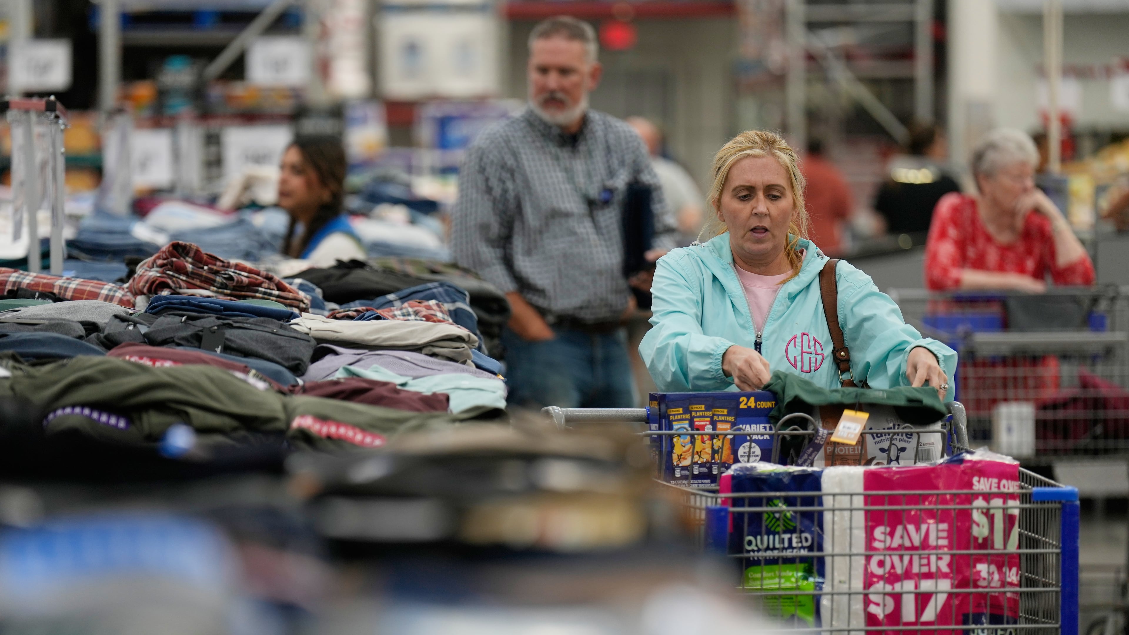 People shop for clothing at a Sam's Club, Wednesday, Sept. 24, 2025, in Bentonville, Ark. (AP Photo/Charlie Riedel)