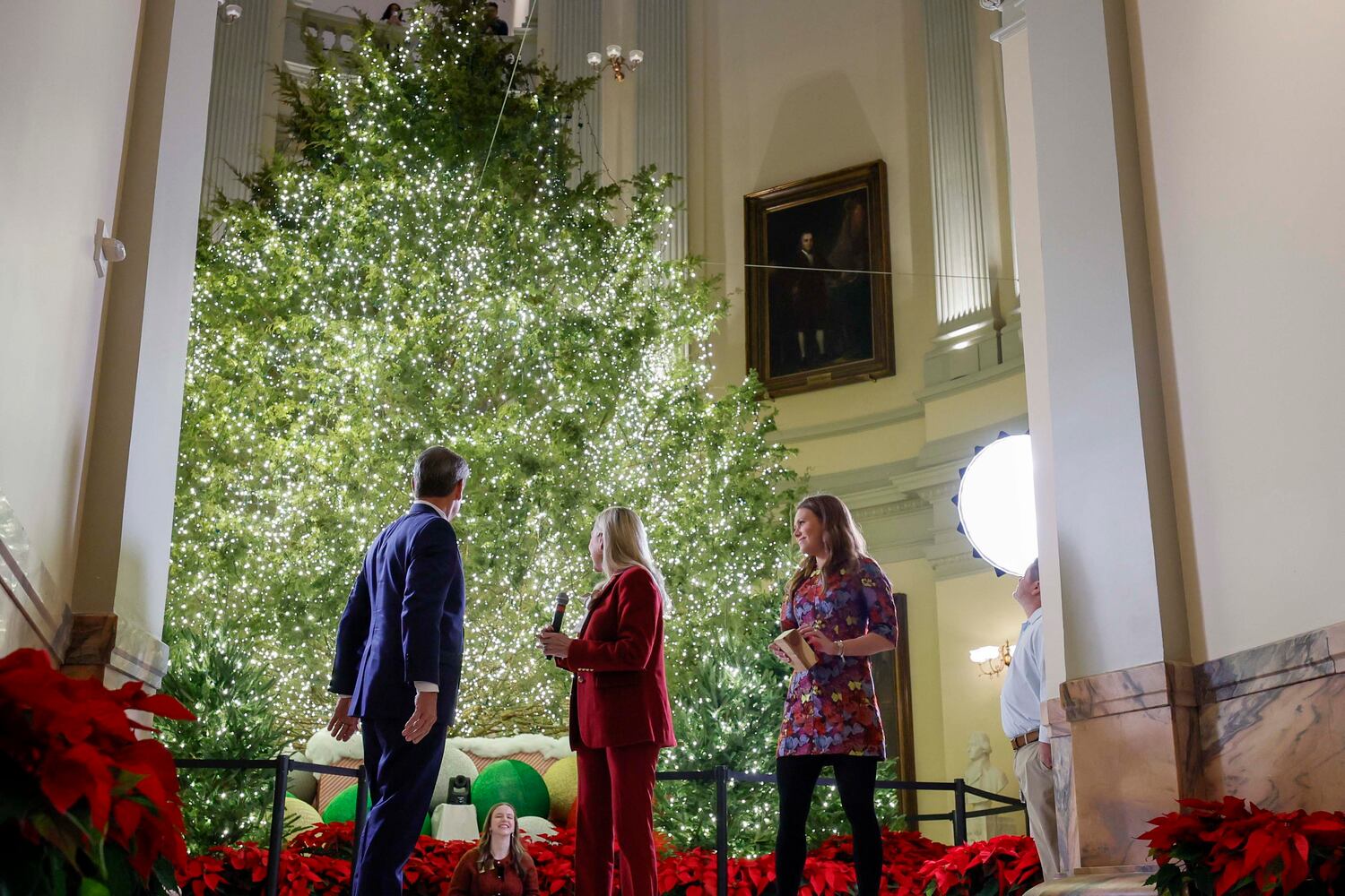 Gov. Brian Kemp and first lady Marty Kemp, along with their daughter Amy Porter Kemp, celebrate after lighting the Christmas Tree to mark the beginning of the 2025 holiday season at the Georgia State Capitol on Monday, Dec 8, 2025. 
(Miguel Martinez/AJC)