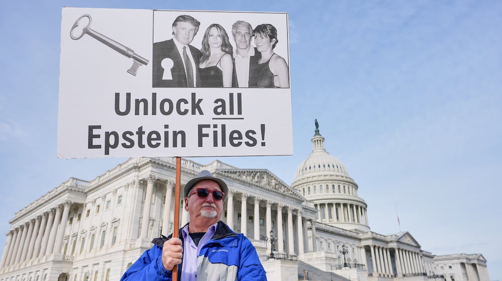 Gary Rush of College Park, Maryland, protests before a news conference on the Epstein files in front of the Capitol in November. (Mariam Zuhaib/AP)