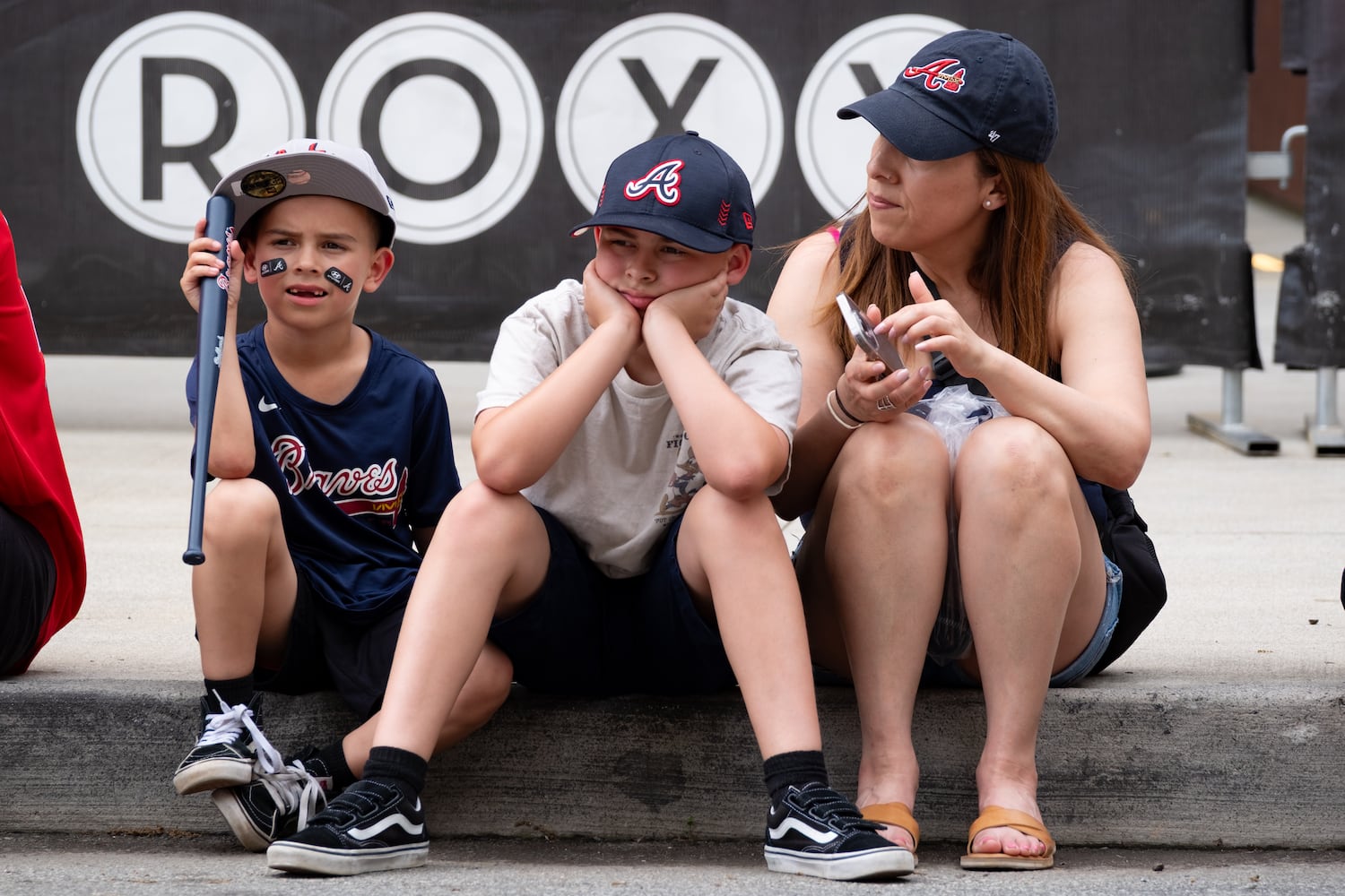 Victor, from left, Vincent and Jordan Vega wait for the Braves Walk before the home opener Friday, April 4, 2025. The family was visiting Atlanta from California. Ben Gray for the Atlanta Journal-Constitution