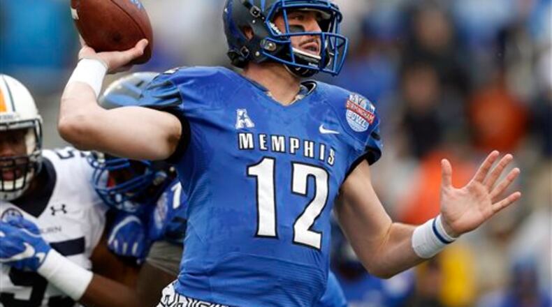 FILE - In this Dec. 30, 2015, file photo, Memphis quarterback Paxton Lynch (12) throws a pass during the first half of the Birmingham Bowl NCAA college football game against Auburn in Birmingham, Ala. The way the spread offense has taken over college football has made the NFL draft even more of a crapshoot. In the past, pro scouts had seen college prospects perform in something similar to the NFL. (AP Photo/Butch Dill, File)