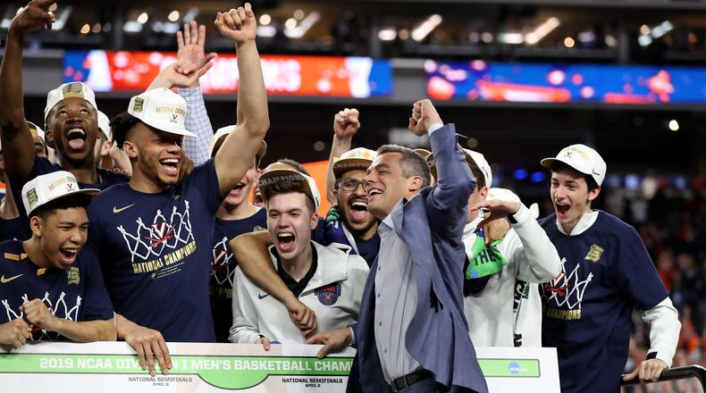 Head coach Tony Bennett of the Virginia Cavaliers places his teams name as National Champion on the bracket after his teams 85-77 win over the Texas Tech Red Raiders during the 2019 NCAA men's Final Four National Championship game at U.S. Bank Stadium on April 08, 2019 in Minneapolis, Minnesota. (Photo by Streeter Lecka/Getty Images)