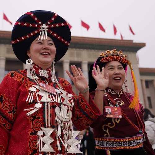 FILE - Ethnic minority delegates wave as they leave after the opening session of the National People's Congress (NPC) at the Great Hall of the People in Beijing, China, Thursday, March 5, 2026. (AP Photo/Vincent Thian, File)