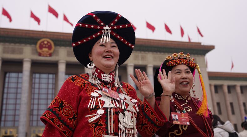 FILE - Ethnic minority delegates wave as they leave after the opening session of the National People's Congress (NPC) at the Great Hall of the People in Beijing, China, Thursday, March 5, 2026. (AP Photo/Vincent Thian, File)