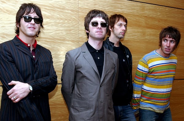 FILE - Members of British rock band Oasis pose for photos ahead of a concert in Hong Kong, Feb. 25, 2006. From left are, Gem Archer, Noel Gallagher, Andy Bell, and Liam Gallagher. (AP Photo/Lo Sai Hung)
